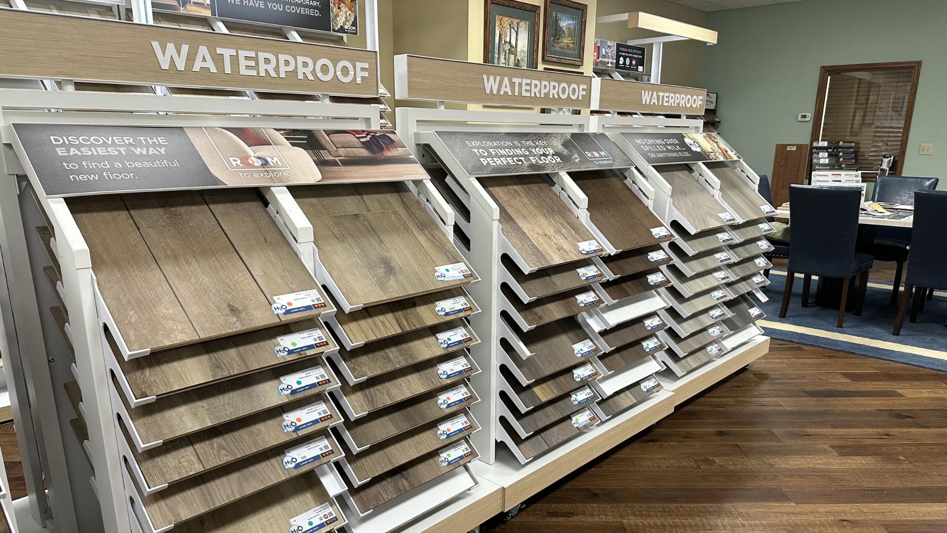 Waterproof luxury vinyl plank flooring display wall at Weaver’s Flooring America showroom serving Harrisonburg Waynesboro and Winchester VA
